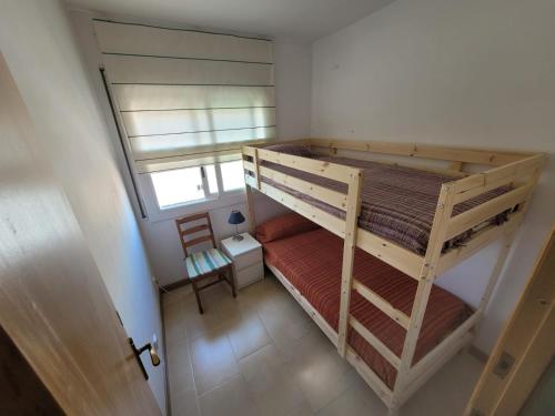 an overhead view of a bedroom with two bunk beds at BRAVAHOLIDAYS-410-Neptuno in Blanes