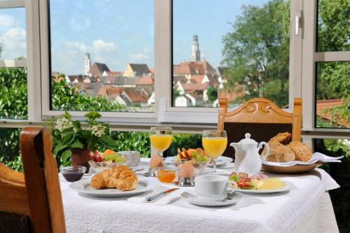 
a table topped with plates of food and drinks at Hotel Kannenkeller in Lauingen
