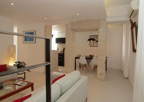 un salon avec un canapé blanc et une table dans l'établissement Le 26, à Nîmes