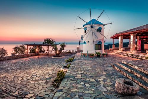 a windmill in the middle of a stone road at Potamitis Windmills & Apartments in Koríthion