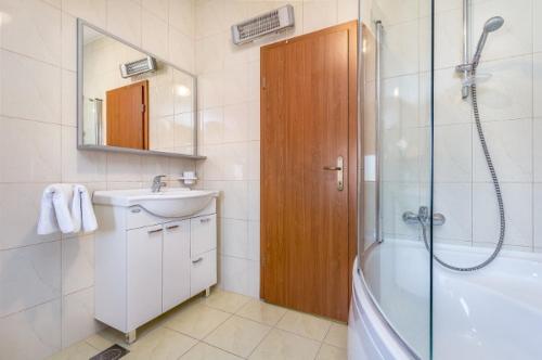 a bathroom with a shower and a sink and a tub at Country Villa (3642) in Loborika