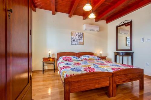 a bedroom with a bed with a colorful comforter at Country Villa (3642) in Loborika