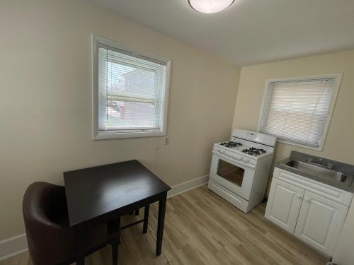 a small kitchen with a stove and a table in it at Wildwood Inn Hotel Travelodge Beach & Boardwalk in Wildwood
