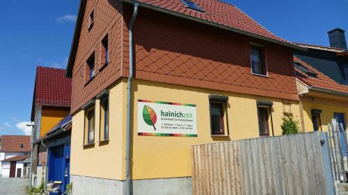 a building with a sign on the side of it at Hainich-Zeit in Eigenrieden