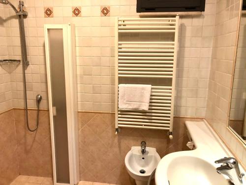 a bathroom with a sink and a toilet and a shower at Hotel San Clemente in Santarcangelo di Romagna