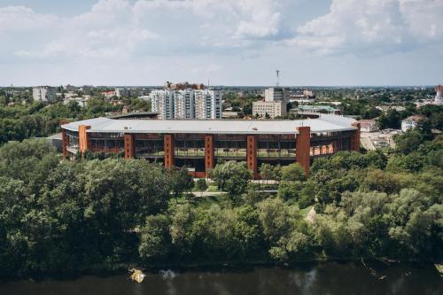 a large building with a roof in a city at Apart Lux Loft Panorama in Sumy