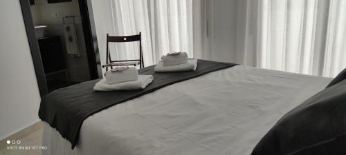 a bed with two towels sitting on top of it at El Enclave in Chulilla