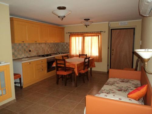 a kitchen with a table and chairs in a room at Agriturismo Le Vigne in Fermo