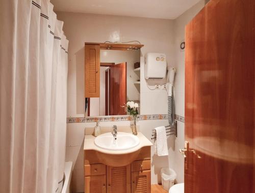 a bathroom with a sink and a mirror at Apartment T3 - Frei Joao - Pleasant and cozy in Tavira