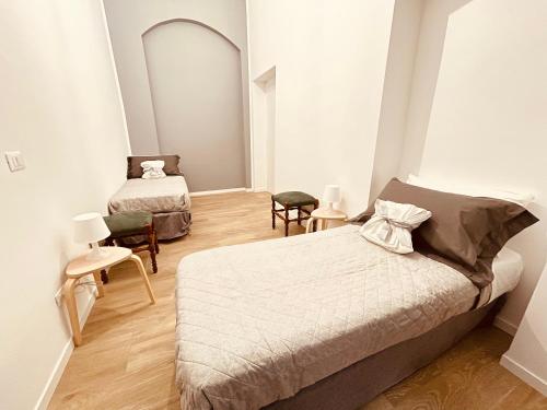 a bedroom with two beds and a mirror at Casa Mole in Turin