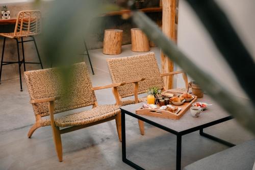two chairs and a table with a tray of food at Emery Hotel in Naxos Chora