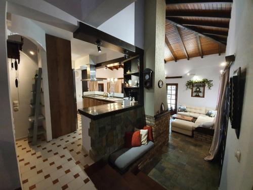 a kitchen and living room with a counter and a couch at VILLA GEORGIA in Acharavi