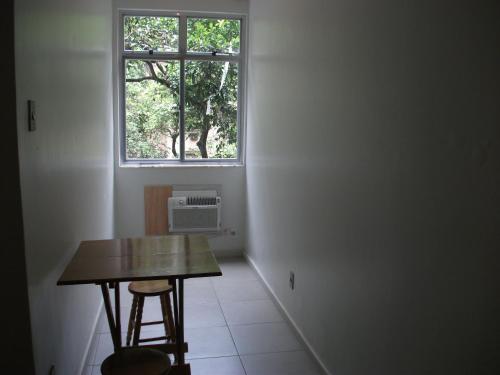 Habitación pequeña con mesa y ventana en Apartamento Barata Ribeiro, en Río de Janeiro