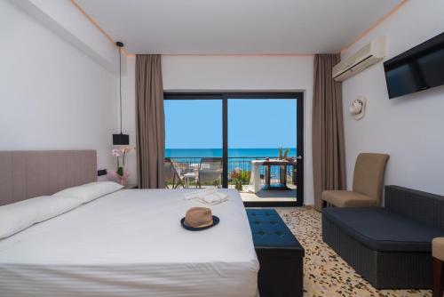 a hotel room with a bed and a view of the ocean at Anastasia Miramar Deluxe Apartments in Zakynthos
