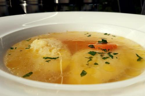 a white bowl of soup with food in it at Tesla's Gastro House Plitvice in Plitvička Jezera