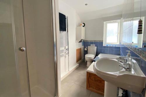 a bathroom with a sink and a toilet at Pebble Beach in Deal