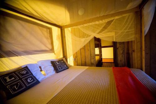 a bedroom with a bed with two pillows on it at VillaLaDiva Boutique Glamping in Massignano
