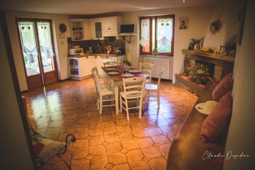 a kitchen and living room with a table and chairs at Il Bosco Guest House Subiaco in Subiaco