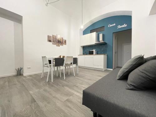 a bedroom with a table and chairs and a kitchen at Casa Reale in Turin