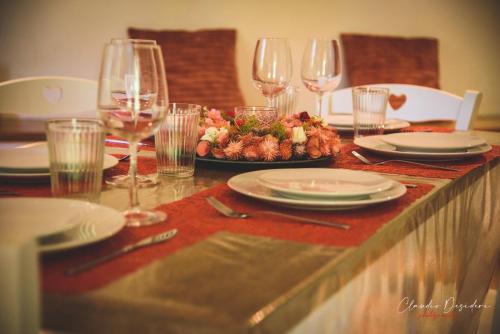 a table with wine glasses and a plate of food at Il Bosco Guest House Subiaco in Subiaco