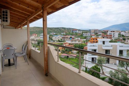 a balcony with a table and chairs and a view at Vila Balani in Ksamil