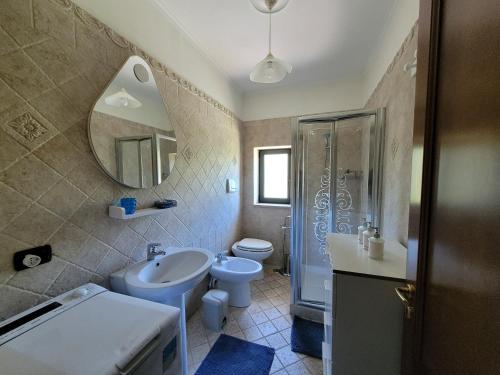 a bathroom with a sink and a toilet and a mirror at Relais Cannavacciuolo in Vico Equense