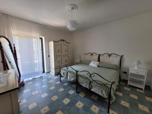 a bedroom with a bed and a tile floor at Relais Cannavacciuolo in Vico Equense
