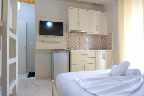 a kitchen with a bed and a tv in a room at Vila Balani in Ksamil