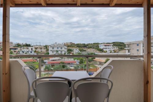 a table and chairs on a balcony with a view at Vila Balani in Ksamil