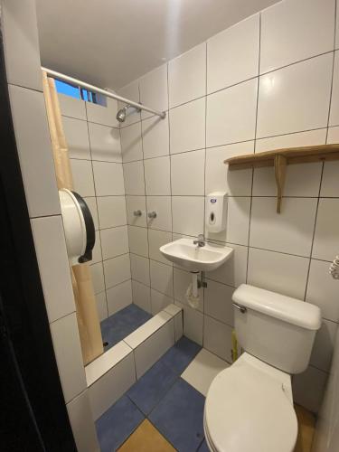 a small bathroom with a toilet and a sink at Black Llama Hostel Miraflores in Lima