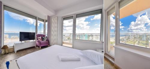 ママイアにあるSea View Penthouse Mamaiaのベッドルーム(白いベッド1台、大きな窓付)