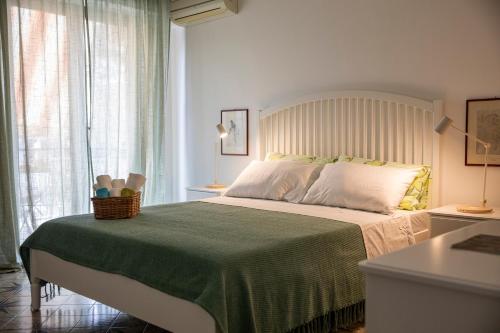 a bedroom with a large bed with a green blanket at Amurusanza in Cefalù