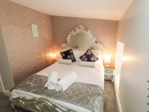 a bedroom with a large bed with towels on it at Corner Cottage Stanhope Castle in Bishop Auckland