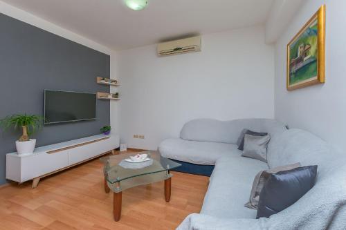 a living room with a couch and a tv at Apartment Josipa in Omiš