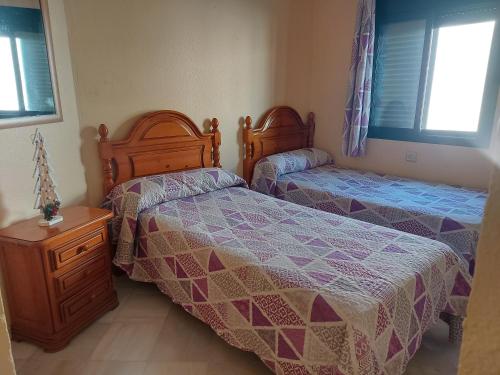 Rúm í herbergi á Precioso apartamento