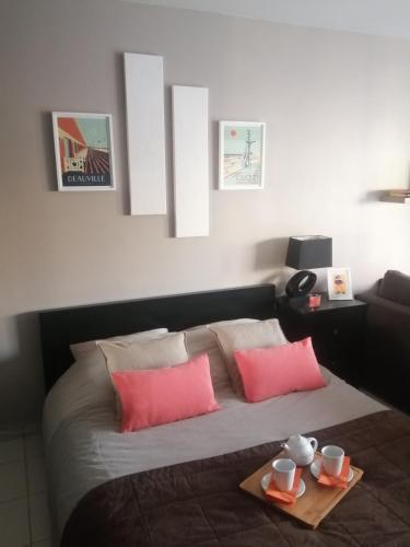 une chambre avec un lit avec deux assiettes de nourriture dessus dans l'établissement L'Escale à Deauville, à Deauville