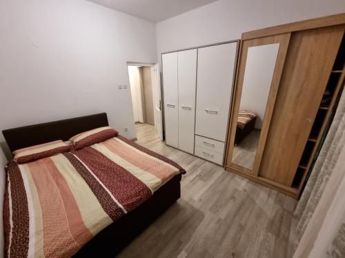 a bedroom with a bed and a large mirror at U kalici in Mali Lošinj