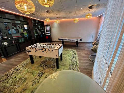 a room with a foosball table and a pool table at Radisson Blu Hotel Bremen in Bremen