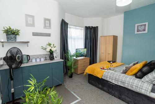 a bedroom with a bed with a yellow blanket at Bentley House with en-suites in Crewe