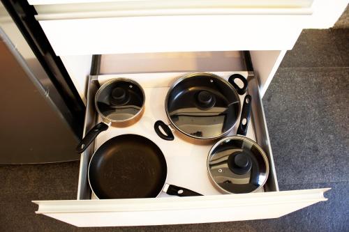 a bunch of pots and pans in a drawer at Suites Aura For Living in Mexico City