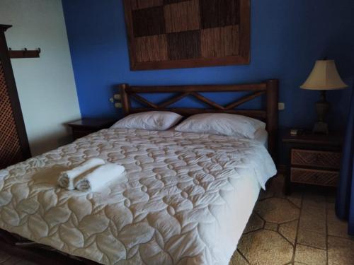a bedroom with a bed with two pillows at Casa Caletas Boutique Hotel in Puerto Coyote