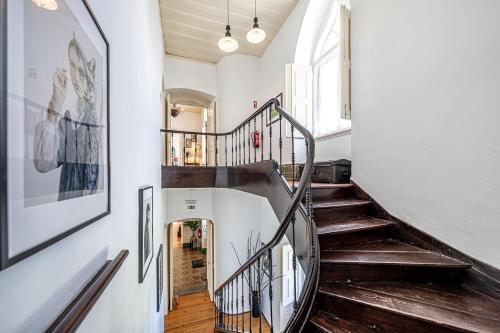 a hallway with a spiral staircase in a house at Dona Amélia in Abrantes