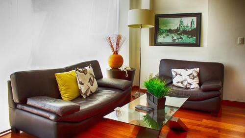 a living room with a couch and a coffee table at Suites Aura For Living in Mexico City