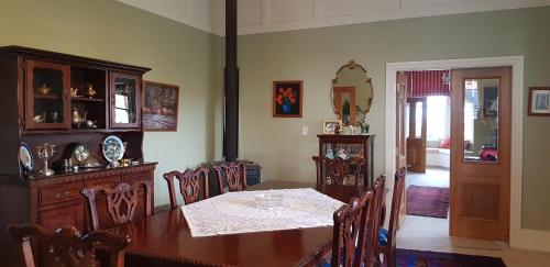 a dining room with a wooden table and chairs at Estancia farm stay in Masterton