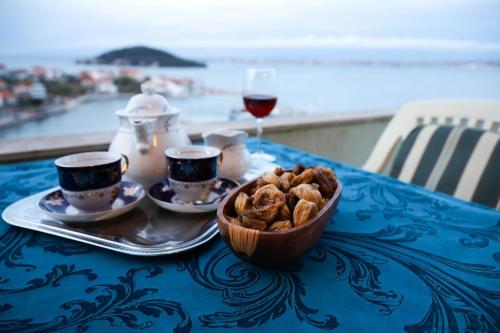 a table with a bowl of food and a glass of wine at Apartment in Kali with Sea View, Balcony, Air Conditioning, Wi-Fi (4566-6) in Kali