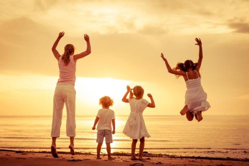 a family jumping on the beach at sunset at Apartment in Kali with Sea View, Balcony, Air Conditioning, Wi-Fi (4566-6) in Kali