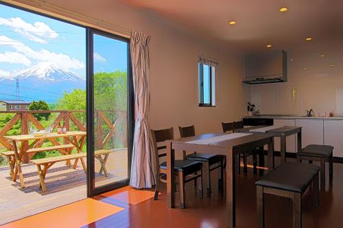 a kitchen and dining room with a view of a mountain at Fujinokura Village in Fujikawaguchiko