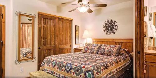 a bedroom with a bed and a ceiling fan at Tyra Riverbend 111 condo in Breckenridge