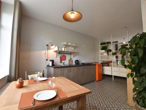 a kitchen with a wooden table with plates on it at Studio in Ieper with terrace in Ieper