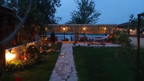 a backyard at night with a person walking in the yard at Dalyan Pension in Dalyan